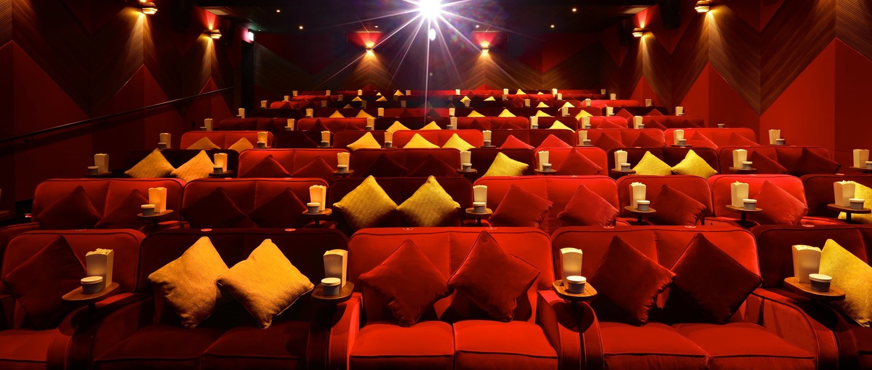 Plush sofas facing the screen in an Everyman private cinema